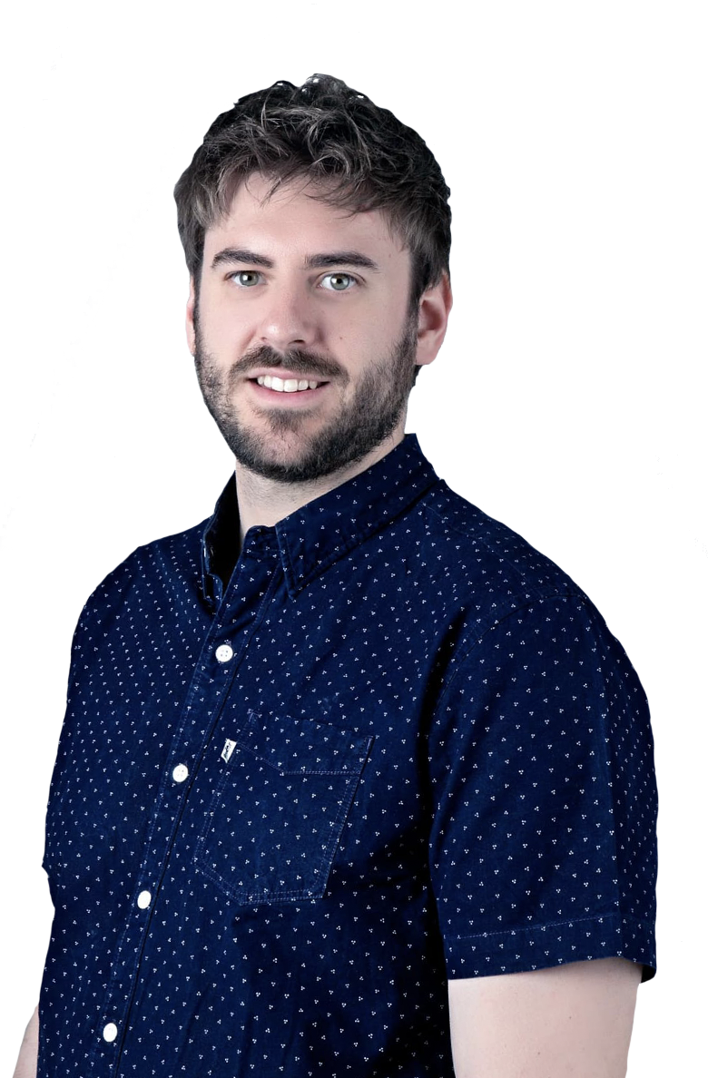 A man in a blue polka dot shirt is smiling. Hire a freelance web designer from Essex for your next project!
