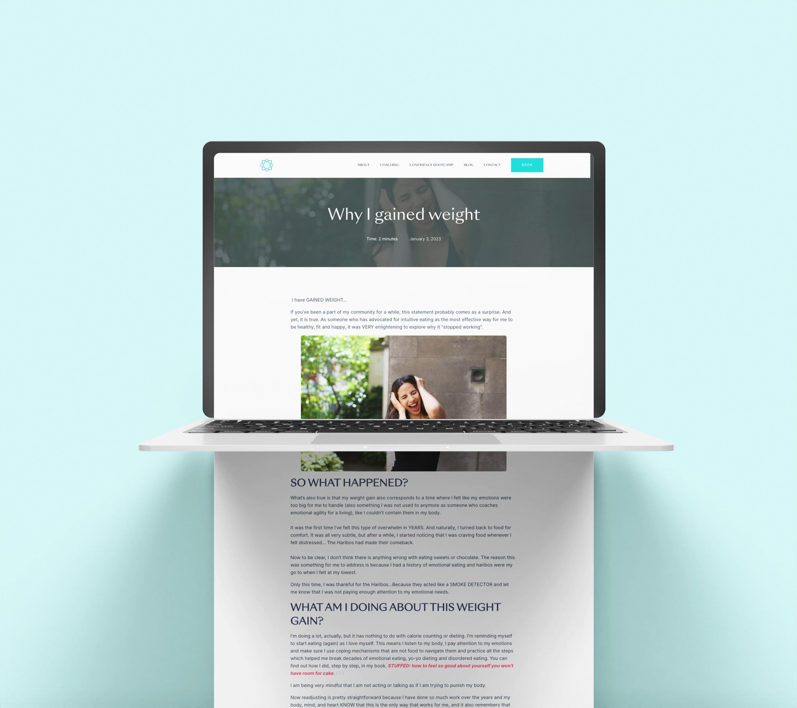 A laptop displaying the face of a freelance web designer.