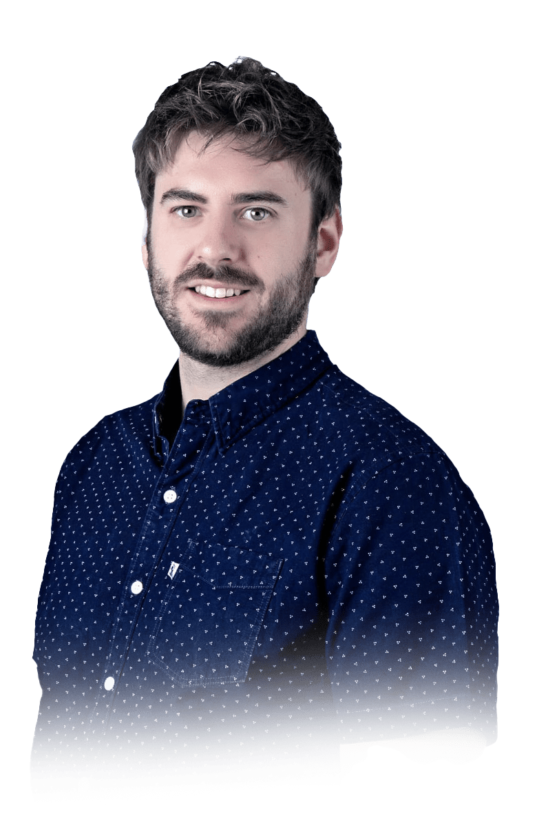 A man in a blue polka dot shirt is smiling, captured by a freelance web designer.